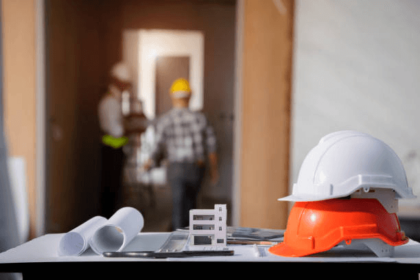 Construction hard hat and blueprints